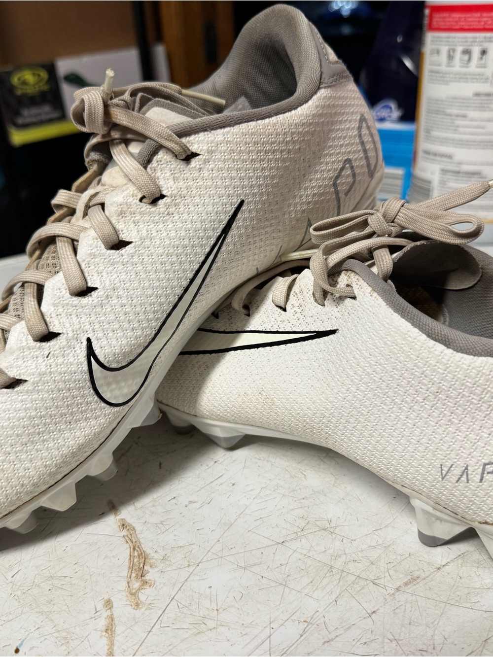 Nike men’s Beige and White football Cleats with Black Swoosh